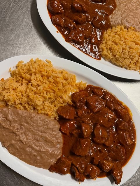 Enchiladas plate with rice, beans and guacamole